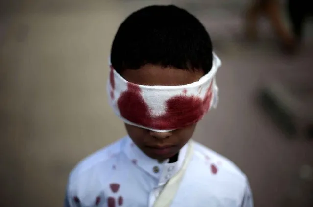 A boy with fake blood on his face and clothes to represent a victim participates in a protest against Saudi-led airstrikes in Sanaa, Yemen, Sunday, November 27, 2016. (Photo by Hani Mohammed/AP Photo)