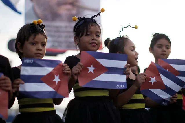 Girls hold Cuban flags as part of a tribute following the announcement of the death of Cuban revolutionary leader Fidel Castro, in San Salvador, El Salvador, November 27, 2016. (Photo by Jose Cabezas/Reuters)