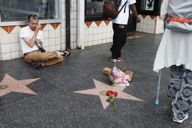 Ryan McDuffie cries while sitting next to Pee-wee Herman's star, a character played by US actor Paul Reubens, in Los Angeles, California, USA, 31 July 2023. Actor Paul Reubens passed away on 30 July 2023 at the age of 70, years after being diagnosed with cancer. (Photo by Caroline Brehman/EPA)