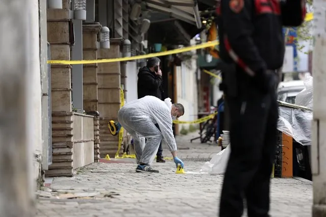 A policeman investigates the area outside Dine Hoxha mosque after a knife attack in Tirana, Albania, Monday, April 19, 2021. Monday, April 19, 2021. Police say an Albanian man with a knife has attacked five people at a mosque in the capital of Tirana. A police statement said Rudolf Nikolli, 34, entered the Dine Hoxha mosque in downtown Tirana about 2:30 p.m. and wounded five people with a knife. (Photo by AP Photo/Stringer)