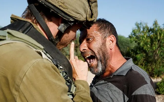 A Palestinian protester argues with an Israeli soldier during a protest against Israeli settlement activity in Qalqilya in the Israeli-occupied West Bank on June 9, 2022. (Photo by Mohamad Torokman/Reuters)