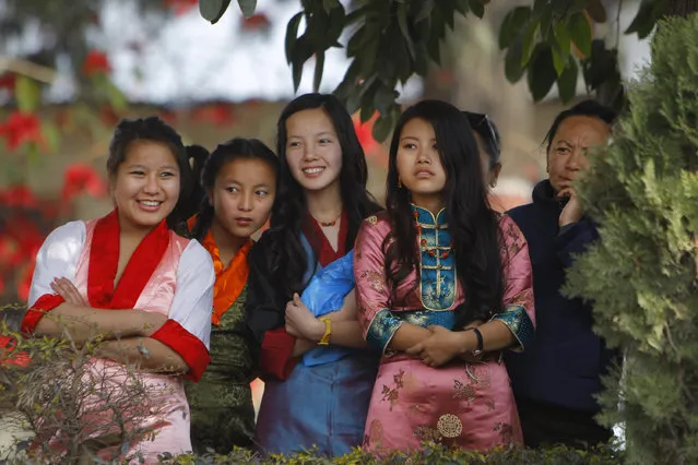 Tibetan girls watch a cultural show during celebrations to mark Tibetan New Year, or Losar, inside the Tibetan Refugee Camp in Lalitpur, Nepal, Thursday, February 19, 2015. Tibetans across the world marked the arrival of the New Year with prayers and festivities. (Photo by Niranjan Shrestha/AP Photo)