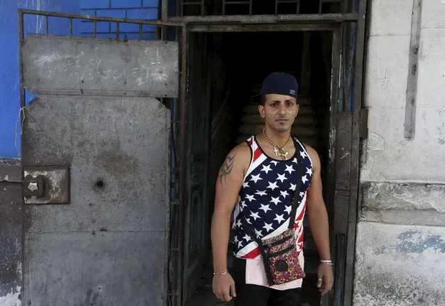 Yasiel, 28, wearing a shirt with the U.S flag, stands on a street in Havana July 2, 2015. (Photo by Alexandre Meneghini/Reuters)