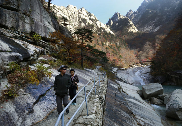 In this October 23, 2018, photo, local tourists walk on the trail at Mount Kumgang, North Korea. At the height of South Korea's policy of engagement with the North, the “Diamond Mountain Resort” area was a symbol of cooperation. More than 2 million South Korean tourists came to visit and some of the South's biggest corporations poured more than a billion dollars into what they hoped would be a world-class travel destination. Today it's almost deserted after Seoul suspended all travel to Kumgang following the fatal shooting of a South Korean tourist in 2008. (Photo by Dita Alangkara/AP Photo)