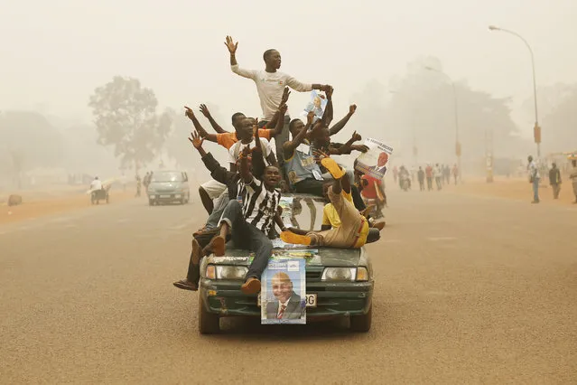 Supporters of Presidential candidate Faustin Archange Touadera rally during a sand storm in the streets of  Bangui, Central African Republic, February 12, 2016. Two former prime ministers, Touadera and  Anicet Georges Dologuele, are running neck-and-neck in the second round of presidential elections Sunday Feb. 14  to end years of violence pitting Muslims against Christians in the Central African Republic. (Photo by Jerome Delay)/AP Photo
