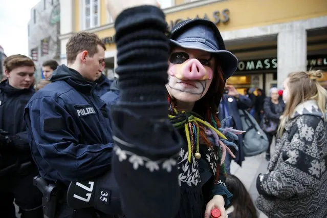 A protester reacts while being photographed during a demonstration against the Munich Security Conference in downtown Munich, Germany, February 13, 2016. (Photo by Michael Dalder/Reuters)