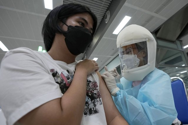A health worker administers a dose of the AstraZeneca COVID-19 vaccine at the Central Vaccination Center in Bangkok, Thailand, Thursday, July 15, 2021. (Photo by Sakchai Lalit/AP Photo)