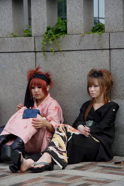 A couple of ladies dressed up the day in a modern take on the summer kimono (Yukata). One smokes a butt. Harajuku, Tokyo. (Photo by Daren Epstein)