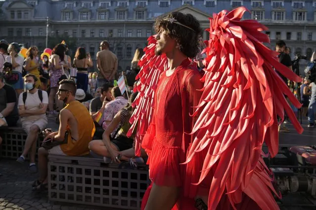 A participant wears a red outfit during the gay pride march in Bucharest, Romania, Saturday, August 14, 2021. Several thousand LGBT supporters took to the streets in the Romanian capital of Bucharest Saturday for a gay pride parade which resumed after a year's pause due to the pandemic. (Photo by Vadim Ghirda/AP Photo)