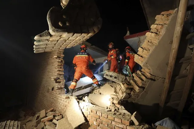 Rescuers work on the rubble of a house that collapsed in the earthquake in Kangdiao village of Jishishan county in northwestern China's Gansu province Tuesday, December 19, 2023. An overnight earthquake killed multiple people in a cold and mountainous region in northwestern China, the country's state media reported Tuesday. (Photo by Chinatopix via AP Photo)