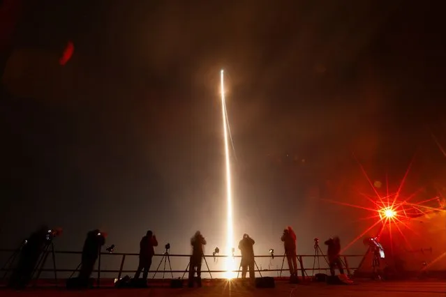 People take photographs during the launch of Boeing-Lockheed joint venture United Launch Alliance's next-generation Vulcan rocket on its debut flight from Cape Canaveral, Florida, U.S. January 8, 2024. (Photo by Joe Skipper/Reuters)