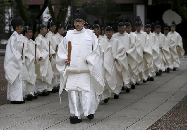Shinto priests walk toward to the main shrine for a ritual to cleanse themselves during Annual Spring Festival at the Yasukuni Shrine in Tokyo April 21, 2015. (Photo by Issei Kato/Reuters)