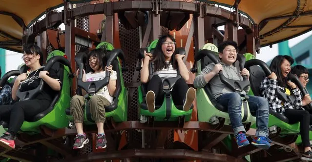 People ride an attraction at Taipei Amusement Park in Taipei, Taiwan, Saturday, March 5, 2016. (Photo by Chiang Ying-ying/AP Photo)