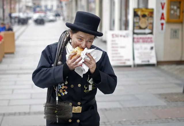 Dajana Djuric, 25, who has worked as a chimney sweep since the age of six, eats after cleaning chimneys in Brcko, Bosnia and Herzegovina. Picture taken March 3, 2016. (Photo by Dado Ruvic/Reuters)