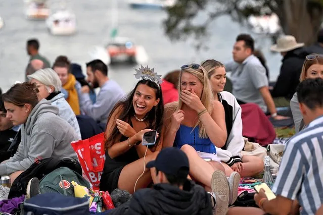 People gather to celebrate the New Year's Eve in Sydney, Australia on December 31, 2022. (Photo by Jaimi Joy/Reuters)