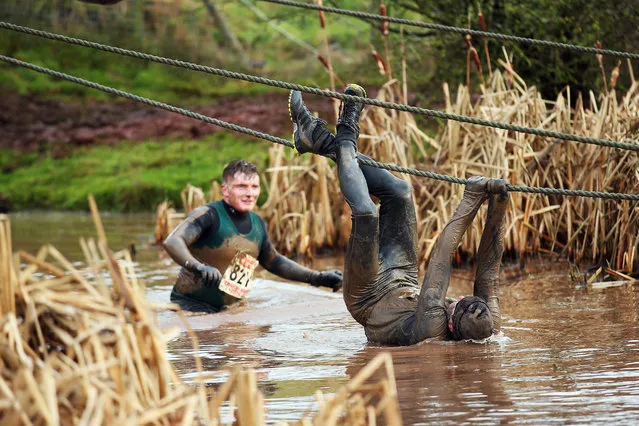 A competitor tries to avoid the water during the Tough Guy Challenge on January 26, 2014 in Telford, England.  (Photo by Bryn Lennon/Getty Images)
