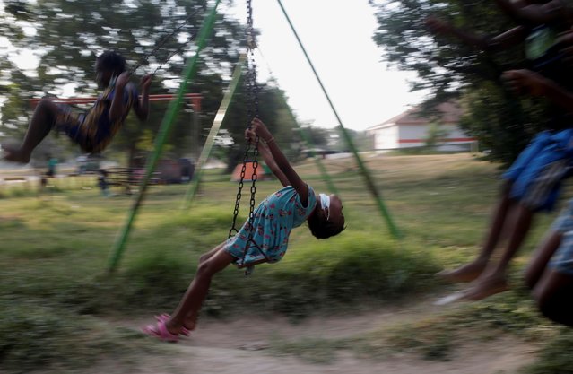 Children play on a swingset in a makeshift migrant camp near the border with the U.S., in Ciudad Acuna, Mexico September 21, 2021. (Photo by Daniel Becerril/Reuters)