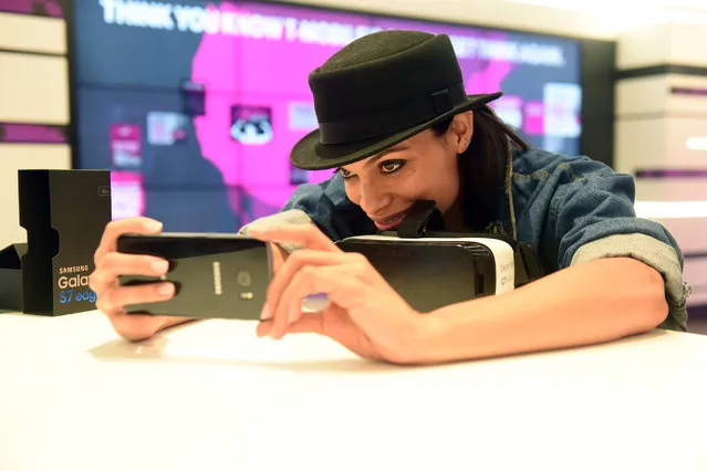 Rosario Dawson takes a “selfie” at the T-Mobile Times Square Signature Store to help celebrate the launch of the Samsung Galaxy S7, Thursday, March 10, 2016, in New York. (Photo by Diane Bondareff/Invision for T-Mobile/AP Images)