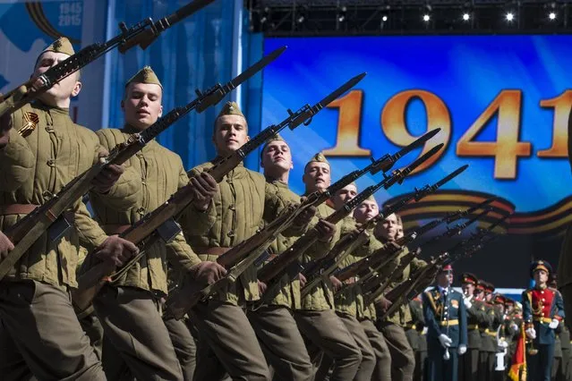 Russian army soldiers, dressed in WWII era uniforms, march along the Red Square during a general rehearsal for the Victory Day military parade which will take place at Moscow's Red Square on May 9 to celebrate 70 years after the victory in WWII, in Moscow, Russia, Thursday, May 7, 2015. (Photo by Alexander Zemlianichenko/AP Photo)