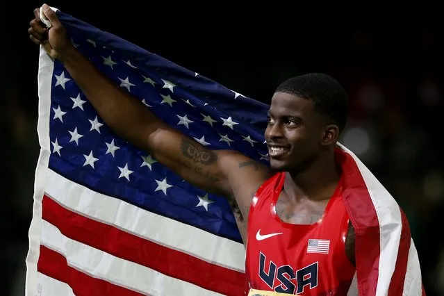 Trayvon Bromell of the U.S. celebrates with an American flag after winning the gold medal in the men's 60 meters at the IAAF World Indoor Athletics Championships in Portland, Oregon March 18, 2016. (Photo by Lucy Nicholson/Reuters)