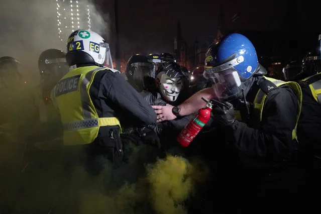 Police clash with protesters as they take part in the Million Mask March 2021 in Parliament Square, London on Friday, November 5, 2021. (Photo by Yui Mok/PA Images via Getty Images)