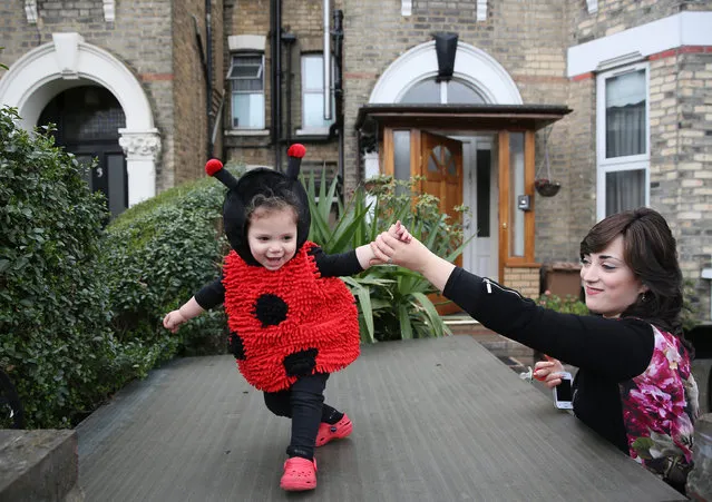 A woman holds a young girl as she dances during celebrations for the Jewish festival of Purim in Stamford Hill in north London, Britain March 24, 2016. (Photo by Neil Hall/Reuters)