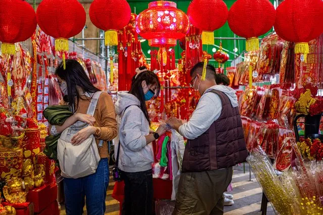 People shop for decorations for Chinese New Year at Jianguo Holiday Flower Market on February 03, 2024 in Taipei, Taiwan. Lunar New Year is the beginning of the new year based on the lunar calendar. It is one of the most important holidays in Chinese culture. Members of the family sit around a big table to have a Chinese New Year's Eve dinner together, which will be on February 9 this year. (Photo by Annabelle Chih/Getty Images)