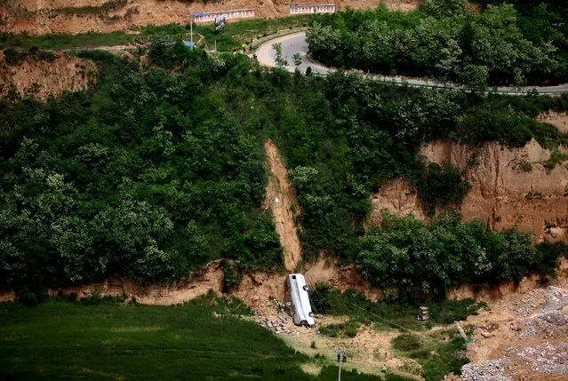 A bus is seen after overturning and falling into a valley in Chunhua county in Xianyang, Shaanxi province, China, May 16, 2015. At least 35 people were killed in the accident when the bus carrying 46 people plunged into a ravine on Friday, Xinhua News Agency reported. (Photo by Reuters/Stringer)
