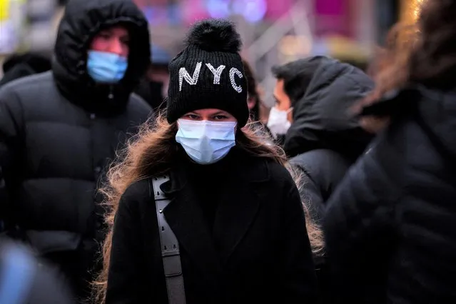 A person waits in a queue for a coronavirus disease (COVID-19) test in Times Square as the Omicron coronavirus variant continues to spread in Manhattan, New York City, U.S., December 19, 2021. (Photo by Andrew Kelly/Reuters)
