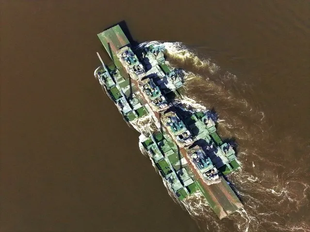 In this aerial view Pandur II armoured personnel carriers of the Czech Army ride a German M3 ferry to cross the Elbe River during the Wettiner Schwert 2024 (Wettin Sword 2024) military exercises on March 26, 2024 in Tangermunde, Germany. Wettiner Schwert is a NATO exercise and part of the larger Quadriga exercises, which in turn are part of the ongoing NATO Steadfast Defender military exercises taking place across northern, eastern, central and southeastern Europe. (Photo by Sean Gallup/Getty Images)