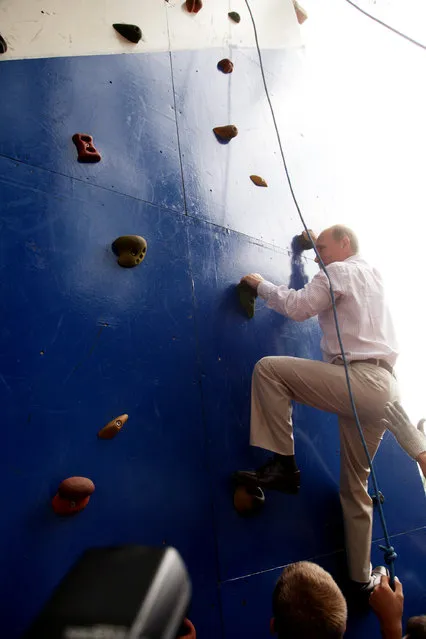 Vladimir Putin attempts a climbing wall at the Seliger educational youth forum at Lake Seliger, Tver Region, Russia, on August, 1, 2011. (Photo by Sasha Mordovets/Getty Images)