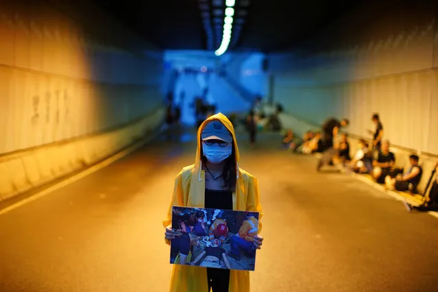 A protester holds a picture of an injured demonstrator, during a demonstration demanding Hong Kong's leaders to step down and withdraw the extradition bill, in Hong Kong, China, June 17, 2019. (Photo by Athit Perawongmetha/Reuters)