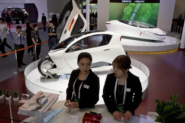 Staffers from Lingyun technology which is promoting the idea of two wheeled cars showcase their concept vehicles in Beijing, China, Monday, April 25, 2016. (Photo by Ng Han Guan/AP Photo)
