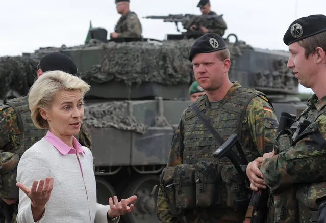 German Defence Minister Ursula von der Leyen speaks with German soldiers after the NATO Noble Jump exercise on a training range near Swietoszow Zagan, Poland, Thursday, June 18, 2015. (AP Photo/Alik Keplicz)