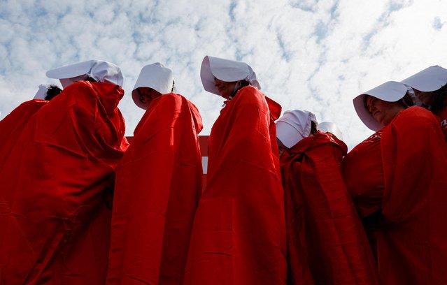 Israeli women wearing red capes demonstrate on the day Israel's constitution committee is set to start voting on changes that would give politicians more power on selecting judges while limiting Supreme Court's powers to strike down legislation, outside the Knesset, Israel's parliament in Jerusalem on February 13, 2023. (Photo by Ammar Awad/Reuters)