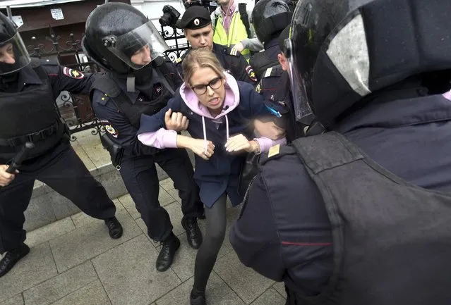 Police officers detain an opposition candidate and lawyer at the Foundation for Fighting Corruption Lyubov Sobol in the center of Moscow, Russia, Saturday, August 3, 2019. Moscow police detained more than 300 people Saturday who are protesting the exclusion of some independent and opposition candidates from the city council ballot, a monitoring group said. (Photo by Dmitry Serebryakov/AP Photo)