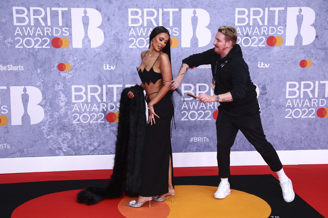 British television, radio presenter and DJ Maya Jama has her hair brushed upon arrival at the Brit Awards 2022 in London Tuesday, February 8, 2022. (Photo by Joel C. Ryan/Invision/AP)