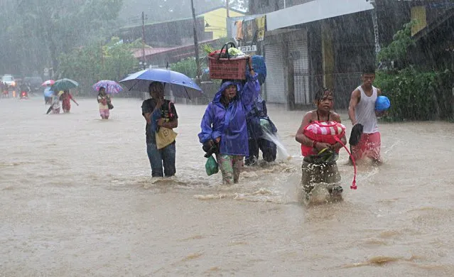 Residents wade along a flooded road after tropical storm Linfa hit San Fernando, La Union in northern Philippines July 5, 2015. (Photo by T. J. Corpuz/Reuters)