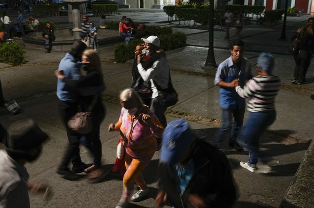 A group of people dance to salsa music in a square in downtown Caracas, Venezuela, Saturday, February 5, 2022. (Photo by Ariana Cubillos/AP Photo)
