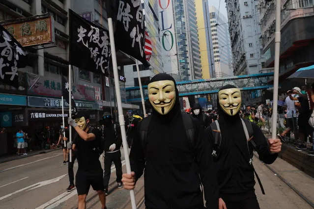 Protestors march wearing masks in Hong Kong on Sunday, September 29, 2019. (Photo by Kin Cheung/AP Photo)