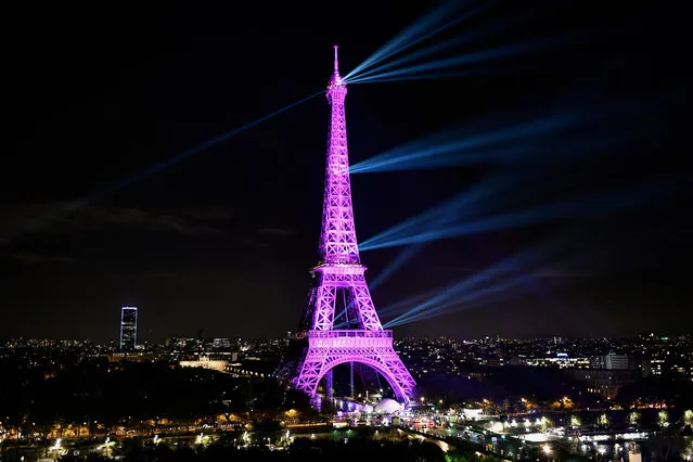 A picture taken on October 1, 2019 shows the Eiffel tower illuminated in pink to mark the start of “Octobre Rose” (Pink October) or Breast Cancer Awareness Month in Paris. (Photo by Stephane de Sakutin/AFP Photo)