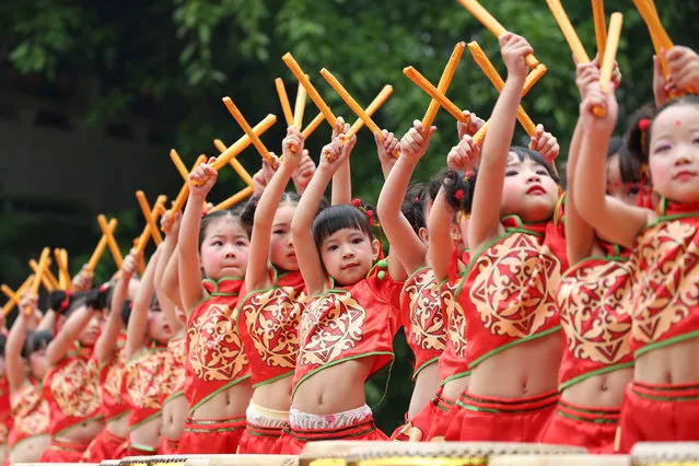 Children wearing costumes perform with drums in Guangan, Sichuan province, China May 10, 2017. (Photo by Reuters/Stringer)