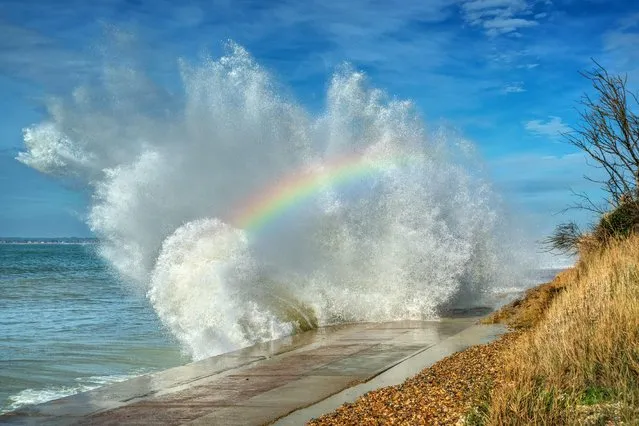 Some wave over the rainbow – a splash of colour is captured in spray over the sea wall at Totland Bay on the Isle of Wight off the south coast of England on February 16, 2022. (Photo by Jamie Russell/Bournemouth News)