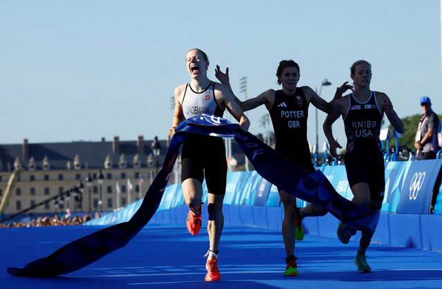 Laura Lindemann of Team Germany crosses the finish line to win the Gold medal ahead of Beth Potter of Team Great Britain and Taylor Knibb of Team United States during the Mixed Relay on day ten of the Olympic Games Paris 2024 at Pont Alexandre III on August 05, 2024 in Paris, France. (Photo by Albert Gea/Reuters)