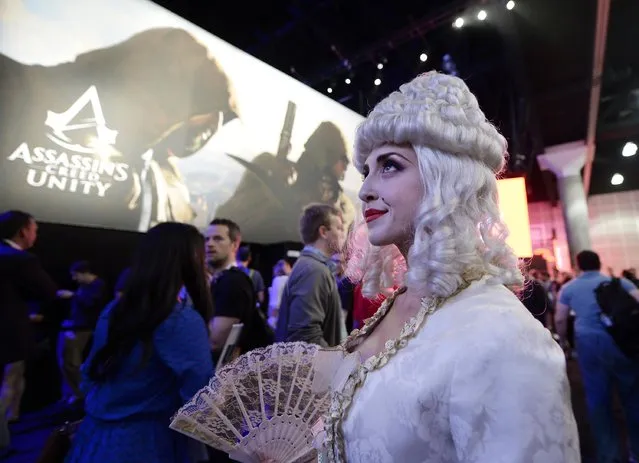 A woman dressed as Marie Antoinette from the video game "Assassin's Creed: Unity" promotes the game in the Ubisoft booth at the 2014 Electronic Entertainment Expo, known as E3, in Los Angeles, June 10, 2014.  REUTERS/Kevork Djansezian