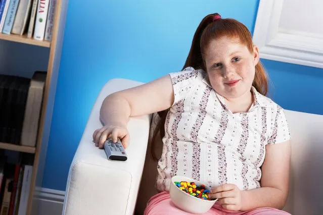 Overweight child eating junk food. (Photo by Moodboard/Getty Images)