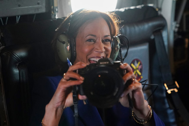 Democratic presidential candidate and US Vice President Kamala Harris reacts as she holds a photographer's camera while flying on Marine Two, on her way to O'Hare International Airport, Chicago, Illinois, on August 20, 2024. Harris is traveling to Milwaukee, Wisconsin, to speak at a campaign event. (Photo by Kevin Lamarque/Pool via  AFP Photo)