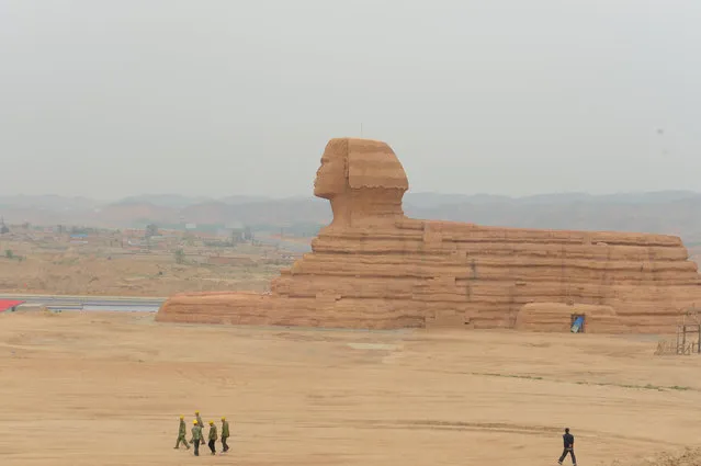 People walk near a replica of the Sphinx at a theme park in Lanzhou, Gansu Province, China, May 31, 2016. (Photo by Reuters/Stringer)
