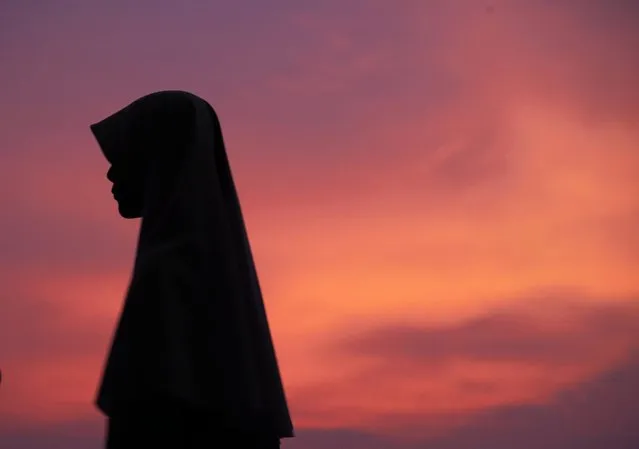 A Malaysian Muslim woman waits for the announcement to mark the start of the fasting month of Ramadan in Putrajaya, outside Kuala Lumpur, Malaysia, on June 27, 2014. (Photo by Shamshahrin Shamsudin/European Pressphoto Agency)