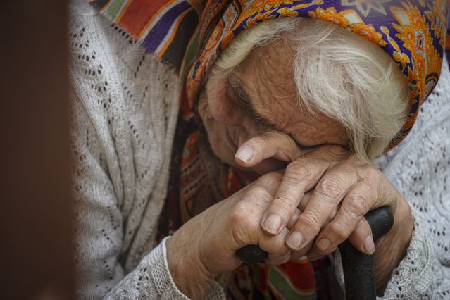 A woman evacuated from the Kursk regional border with Ukraine reacts as she waits to receive humanitarian aid delivered by the Russian Red Cross in downtown Kursk, Russia,19 August 2024. The Assumption-Nikitsky Church is regularly visited by refugees from the Kursk region, where they receive humanitarian aid. Since evacuations began amid a Ukrainian offensive in the area, more than 121,000 people have been resettled from nine border areas. The resettlement of residents from border areas continues, the press service of the Russian Emergencies Ministry reported. (Photo by EPA/EFE/Stringer)